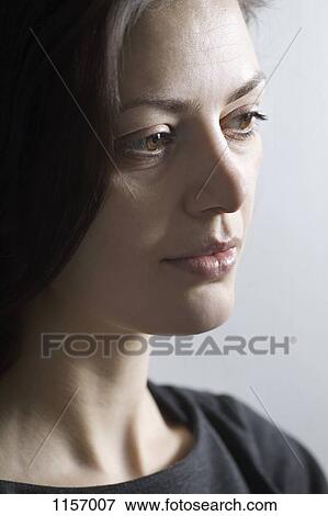 Stock Photo - A woman looking away. Fotosearch