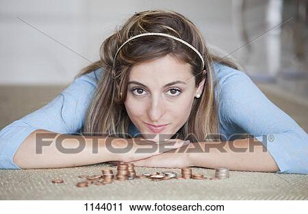 A woman lying on a floor with stacks of US coins View Large Photo Image Stock Image - A woman lying on a floor with stacks of US coins. Fotosearch