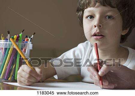 A young boy drawing with a friend, viewpoint of boy View Large Photo Image Stock Photography - A young boy drawing with a friend, viewpoint of boy. Fotosearch
