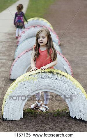 Stock Photography - A young girl in a playground. Fotosearch