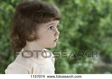 Picture - A young girl looking away. Fotosearch
