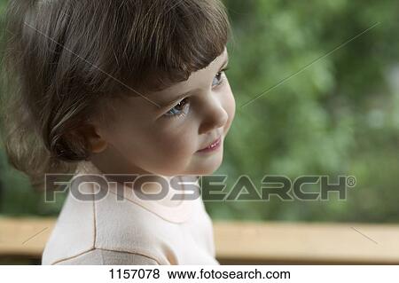 Stock Photo - A young girl looking away. Fotosearch