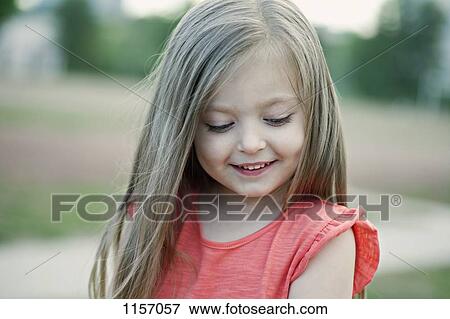 A young girl looking down View Large Photo Image Stock Photo - A young girl looking down. Fotosearch
