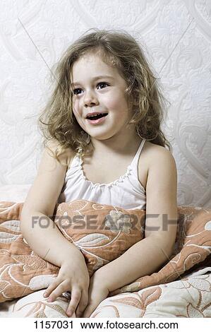 A young girl sitting under a blanket View Large Photo Image Stock Image - A young girl sitting under a blanket. Fotosearch