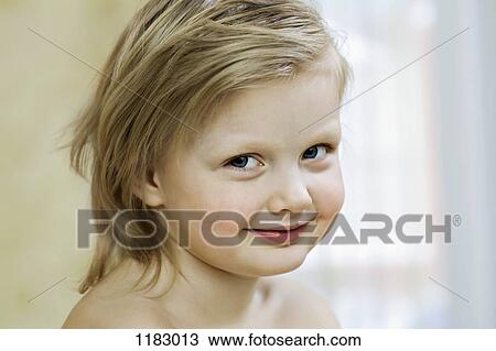 A young girl smiling slyly View Large Photo Image Stock Image - A young girl smiling slyly. Fotosearch