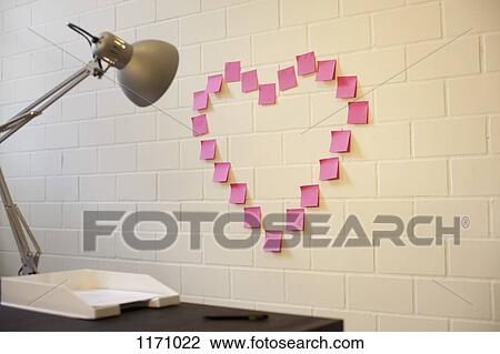 Adhesive notes arranged into the shape of a heart on a wall next to a desk View Large Photo Image Stock Image - Adhesive notes arranged into the shape of a heart on a wall next to a desk. Fotosearch