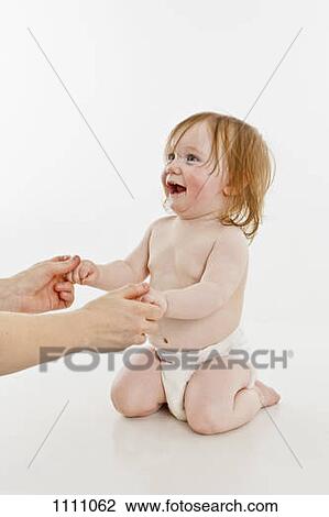 An adult holding the hands of a baby girl View Large Photo Image Stock Image - An adult holding the hands of a baby girl. Fotosearch