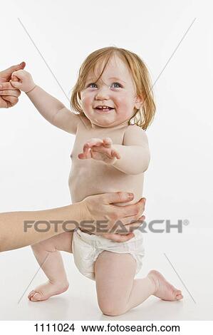 An adult supporting a baby girl View Large Photo Image Picture - An adult supporting a baby girl. Fotosearch