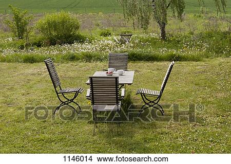 An outdoor table and chairs set for breakfast View Large Photo Image Picture - An outdoor table and chairs set for breakfast. Fotosearch