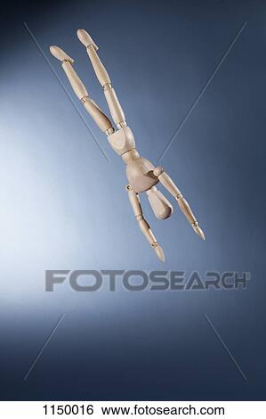 Stock Photograph - An upside down artist's figure falling in mid-air. Fotosearch