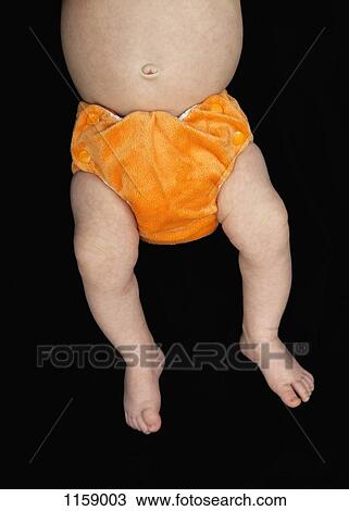 Stock Image - Baby in orange nappy. Fotosearch