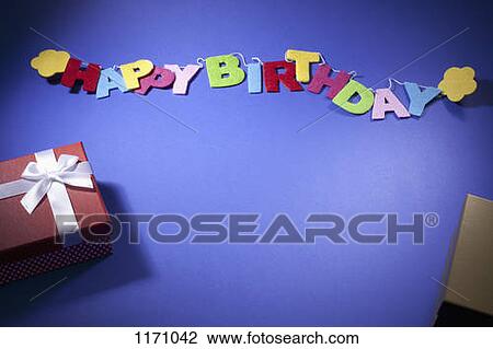 Birthday gifts and a banner reading Happy Birthday View Large Photo Image Stock Image - Birthday gifts and a banner reading Happy Birthday. Fotosearch