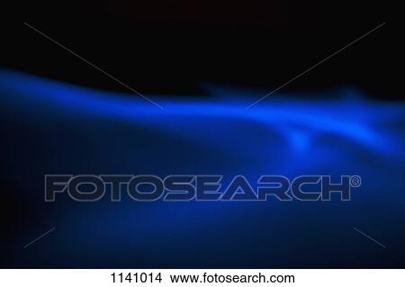 Blue light creating an ethereal effect on a black background View Large Photo Image Picture - Blue light creating an ethereal effect on a black background. Fotosearch