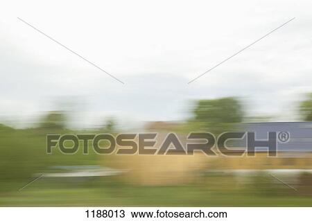 Buildings and landscape in blurred motion viewed from a moving train View Large Photo Image Stock Image - Buildings and landscape in blurred motion viewed from a moving train. Fotosearch