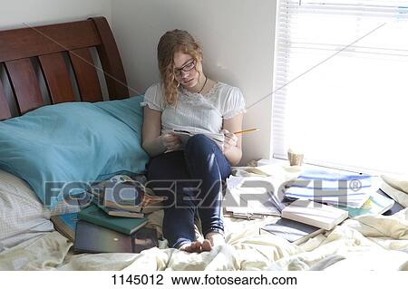 Busy girl with study books on bed View Large Photo Image Stock Image - Busy girl with study books on bed. Fotosearch