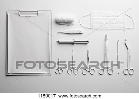 Stock Photo - Clipboard, various medical scissors and instruments painted white and arranged neatly. Fotosearch
