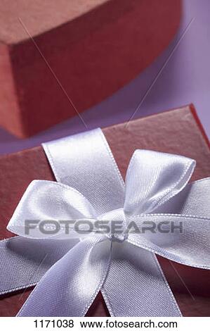 Stock Photo - Close-up of a white bow and ribbon on a gift box. Fotosearch