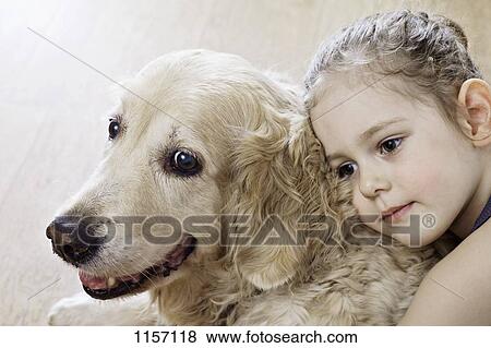 Close-up of a young girl hugging a dog View Large Photo Image Stock Photo - Close-up of a young girl hugging a dog. Fotosearch