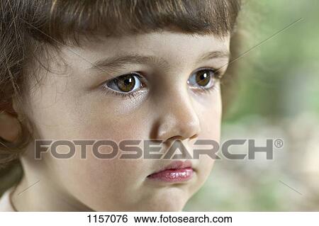 Close-up of a young girl staring View Large Photo Image Stock Photograph - Close-up of a young girl staring. Fotosearch