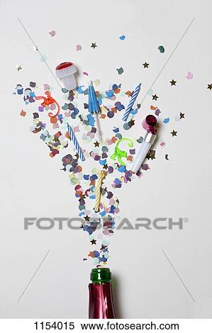 Confetti and party supplies spraying out of a champagne bottle View Large Photo Image Stock Photography - Confetti and party supplies spraying out of a champagne bottle. Fotosearch