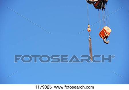 Crane hook against a clear blue sky View Large Photo Image Stock Photography - Crane hook against a clear blue sky. Fotosearch