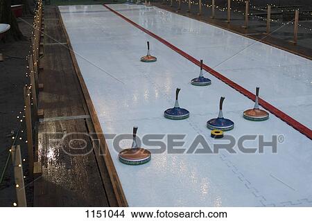 Picture - Curling stones on a curling sheet. Fotosearch