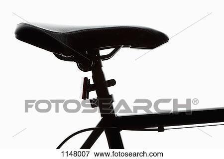 Stock Photo - Detail of a bicycle seat, back lit, studio shot. Fotosearch