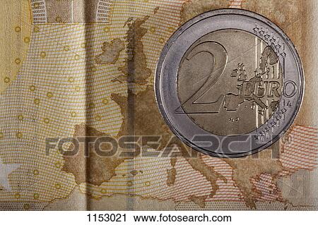 Detail of a fifty Euro banknote with a two Euro coin on top of it View Large Photo Image Stock Image - Detail of a fifty Euro banknote with a two Euro coin on top of it. Fotosearch