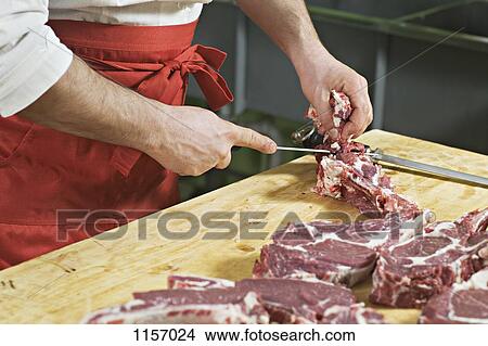 Detail of a man chopping meat View Large Photo Image Picture - Detail of a man chopping meat. Fotosearch