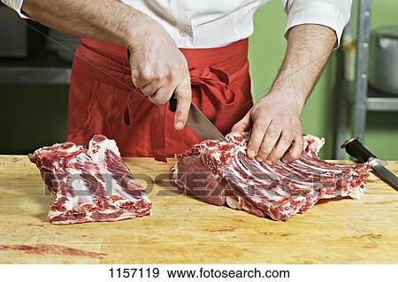 Stock Photo - Detail of a man chopping meat. Fotosearch