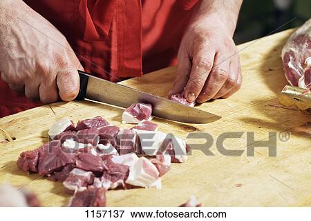 Detail of a man chopping meat View Large Photo Image Stock Photo - Detail of a man chopping meat. Fotosearch