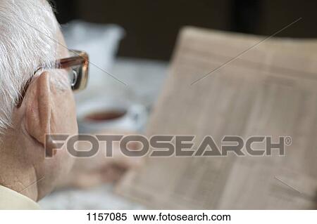 Detail of a senior man reading a newspaper View Large Photo Image Stock Photography - Detail of a senior man reading a newspaper. Fotosearch