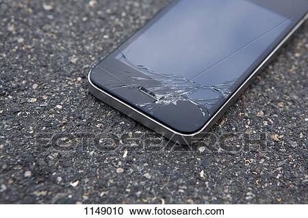 Stock Image - Detail of a smart phone with a cracked screen. Fotosearch