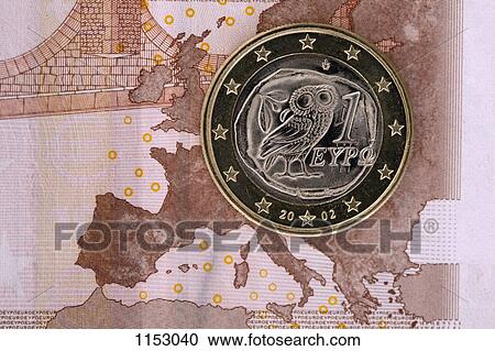 Stock Image - Detail of a ten Euro banknote with a one Euro coin on top of it. Fotosearch