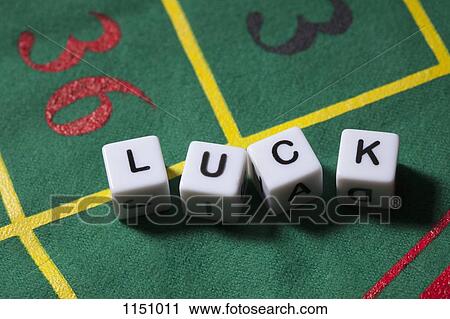 Stock Image - Dice on a gambling table spelling the word LUCK. Fotosearch