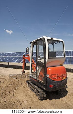 Digger on solar panel construction site View Large Photo Image Picture - Digger on solar panel construction site. Fotosearch
