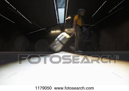 Diminishing perspective of light under trailed luggage in airport View Large Photo Image Stock Image - Diminishing perspective of light under trailed luggage in airport. Fotosearch