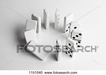 Dominoes in a circle beginning to fall over in a chain reaction View Large Photo Image Stock Image - Dominoes in a circle beginning to fall over in a chain reaction. Fotosearch