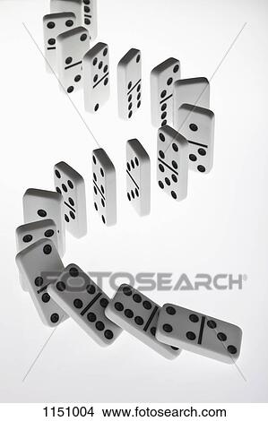 Dominoes in a row, beginning to fall over in a chain reaction View Large Photo Image Picture - Dominoes in a row, beginning to fall over in a chain reaction. Fotosearch