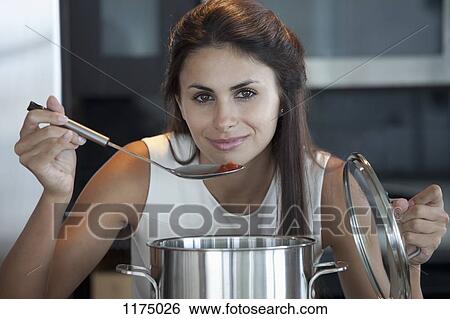 Elegant woman bring ladle to mouth View Large Photo Image Stock Photograph - Elegant woman bring ladle to mouth . Fotosearch