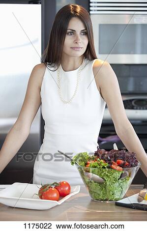 Elegant woman in kitchen with bowl of salad View Large Photo Image Stock Image - Elegant woman in kitchen with bowl of salad. Fotosearch