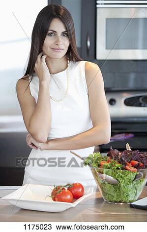 Elegant woman in kitchen with bowl of salad View Large Photo Image Stock Image - Elegant woman in kitchen with bowl of salad. Fotosearch