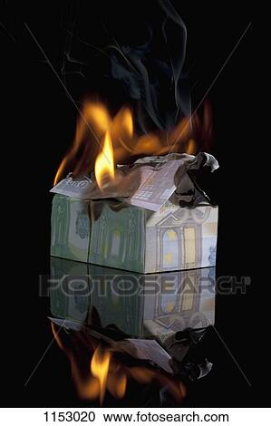 Stock Image - European Union currency folded into a house and on fire. Fotosearch