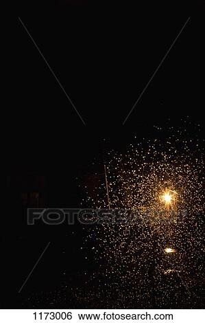 Stock Photograph - Exploding firework against black night sky. Fotosearch