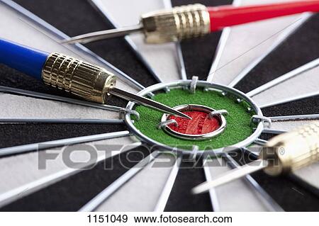 Extreme close up of three darts lying on their side around a bull's eye View Large Photo Image Stock Photo - Extreme close up of three darts lying on their side around a bull's eye. Fotosearch