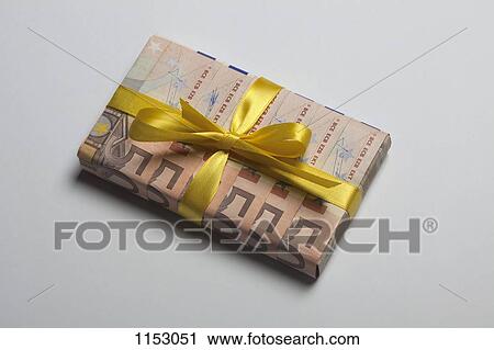 Stock Image - Fifty Euro banknotes used to wrap a gift with a yellow bow. Fotosearch