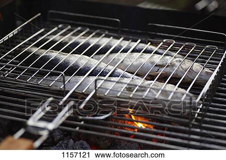 Stock Image - Fish on a barbeque grill. Fotosearch