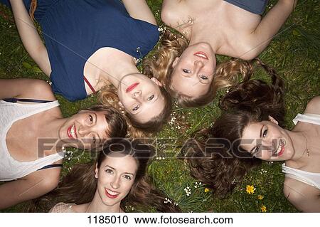 Five cheerful female friends lying in the grass, head and shoulders View Large Photo Image Stock Image - Five cheerful female friends lying in the grass, head and shoulders. Fotosearch