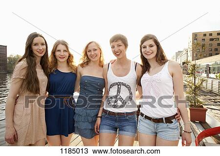 Five cheerful young female friends standing a row, Spree River, Berlin, Germany View Large Photo Image Stock Image - Five cheerful young female friends standing a row, Spree River, Berlin, Germany. Fotosearch