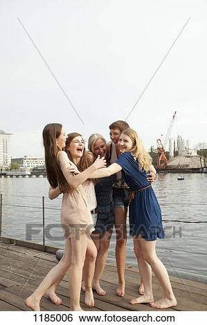 Five female friends embracing and laughing, Spree Rive, Berlin, Germany View Large Photo Image Stock Photograph - Five female friends embracing and laughing, Spree Rive, Berlin, Germany. Fotosearch